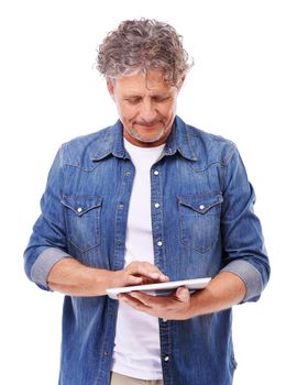 An isolated pose. Studio shot of a mature man using a tablet isolated on white