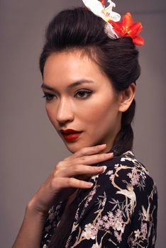 She wanted to honor her lineage. Studio shot of an attractive young woman dressed in traditional asian clothing