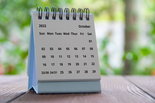 October 2022 table calendar with blurred nature background. Calendar concept.