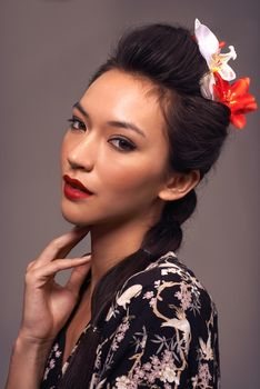 Im honoring my lineage. Studio shot of an attractive young woman dressed in traditional asian clothing