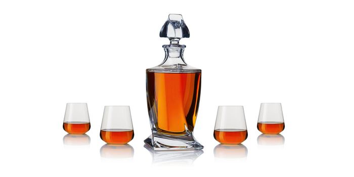 Decanter with cognac. Whiskey decanter on white background. Strong alcoholic drink in a decanter