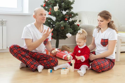 Toddler child with cochlear implant decorating christmas tree deafness and innovating medical technologies for hearing aid