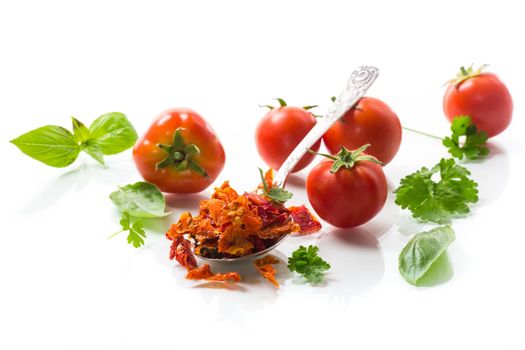 small pieces of dried tomatoes next to fresh tomatoes, natural homemade spices