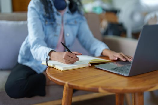 Portrait of African Americans using notebooks, pens to take notes and computers. to study through the Internet, online e learning concept