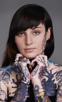 A walking art exhibition. A cropped shot of a tattooed young woman