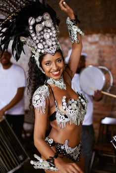 Blame it on the samba. a beautiful samba dancer performing in a carnival with her band