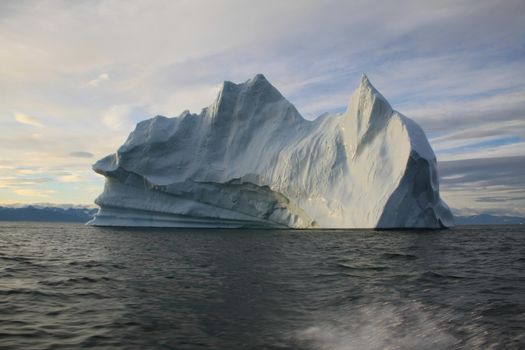 Stranded iceberg and ice near evening in arctic landscape, near Pond Inlet, Nunavut, Canada