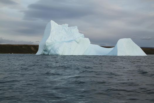 Stranded iceberg and ice near evening in arctic landscape, near Pond Inlet, Nunavut, Canada