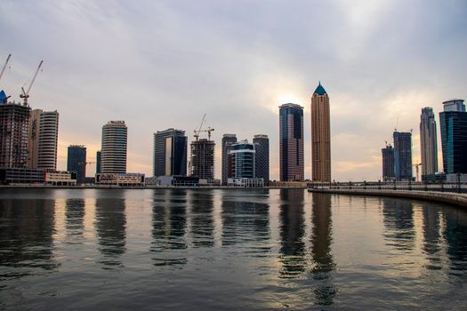 Modern buildings along the Dubai water canal, business bay district UAE. Outdoors