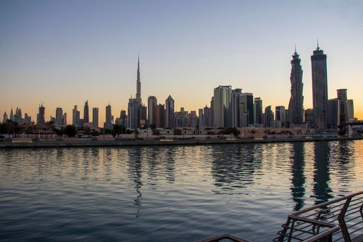 Dubai, UAE - 01.08.2021 View of the Dubai city skyline at Dubai Water Canal. Business Bay district. Tallest building in the world Burj Khalifa can be seen in the picture.