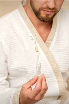 Young caucasian man receiving nasal inhalation Maholda with essential oil in the nose at a hospital