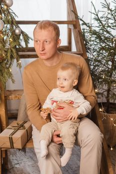 Dad and his little son in a magical Christmas atmosphere. The concept of family relations and New Year celebrations