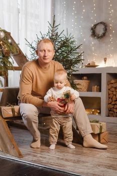 Dad and his little son in a magical Christmas atmosphere. The concept of family relations and New Year celebrations