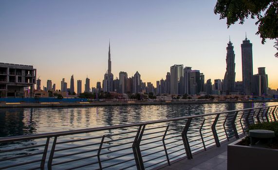 Dubai, UAE - 01.08.2021 View of the Dubai city skyline at Dubai Water Canal. Business Bay district. Tallest building in the world Burj Khalifa can be seen in the picture.