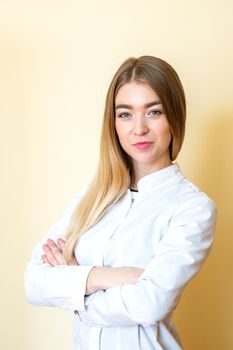 Closeup portrait of a female healthcare professional, dentist, doctor, nurse, the assistant on light yellow background