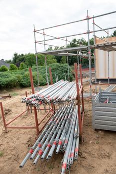 strong metal scaffolding at the construction site of a new house, the beginning of wooden structures around a metal frame. High quality photo