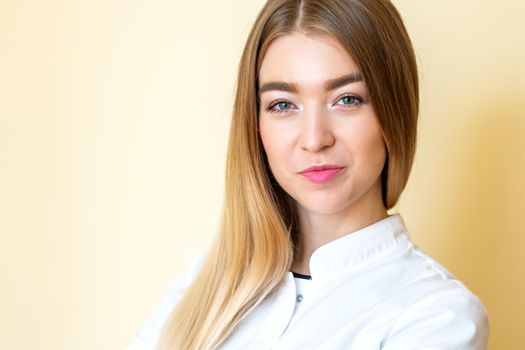 Closeup portrait of a female healthcare professional, dentist, doctor, nurse, the assistant on light yellow background