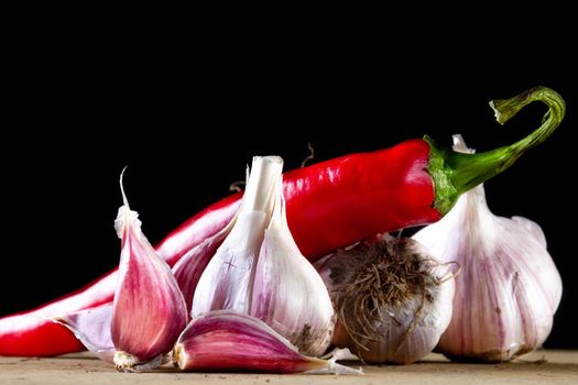 Garlic and pepper. Spicy spices. Hot red pepper. Natural spices. Vegetables on table close-up.