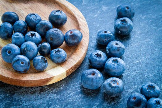 Blueberries on a wooden table. Fresh berries. Wild blueberries on a wooden stand. Copyspace.