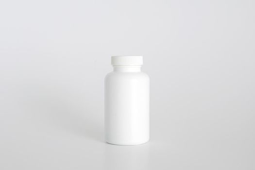 Pills bottle. White medical container for drugs, diet, nutritional supplements. White plastic jar for pills. Packaging mockup template. Free space, copy space