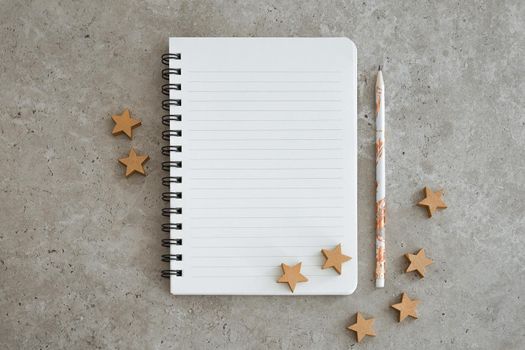 Top view of notebook with Christmas decorations. Goals, plans, dreams and to do list for new year. Free space, copy space, mockup or template for your text