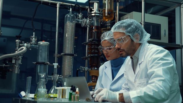 Two scientist in professional uniform working in laboratory for chemical and biomedical experiment