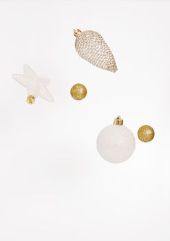 Flying Christmas decoration on the white background. Christmas composition. Free space, copy space. Modern Xmas background