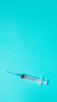 Vaccination debate concept. Biotechnology banner with medical syringe. Copyspace for text. flatlay.