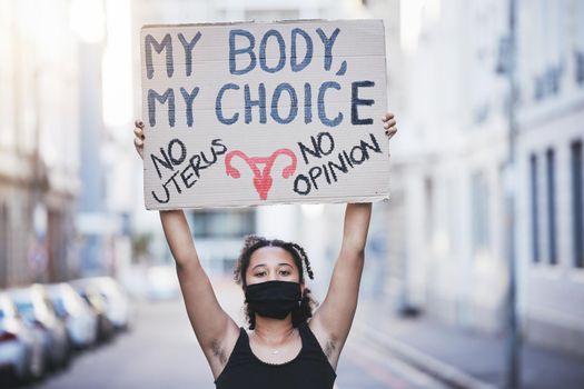 Freedom, protest and abortion with a woman and a poster, fighting for human rights and gender equality. Justice, change and banner in the hands of a young female marching for social justice.