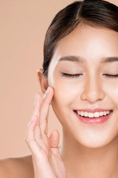 Closeup ardent young woman with healthy clear skin and soft makeup looking at camera and posing beauty gesture. Cosmetology skincare and beauty concept.