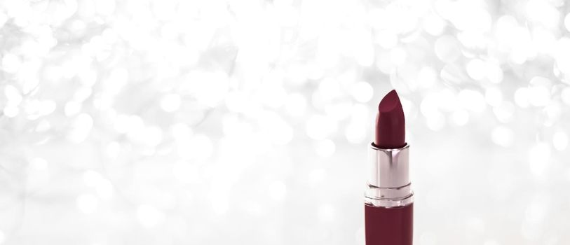Cosmetic branding, sale and glamour concept - Chocolate lipstick on silver Christmas, New Years and Valentines Day holiday glitter background, make-up and cosmetics product for luxury beauty brand