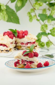 Round meringue pie with fresh raspberries on a white background, Pavlova dessert