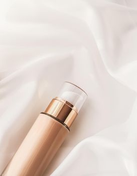 Cosmetic branding, glamour and skincare concept - Tonal bb cream bottle make-up fluid foundation base for nude skin color on silk background, cosmetics product as luxury beauty brand holiday design