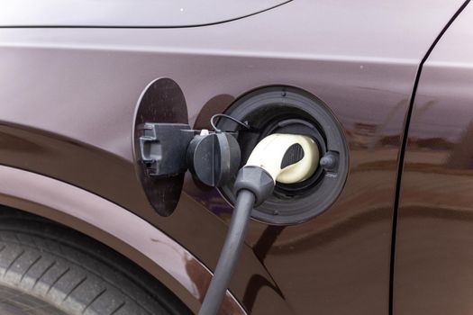 Power supply connect to electric vehicle for charge to the battery. Charging technology industry transport which are the futuristic of the Automobile. EV fuel Plug in hybrid car.
