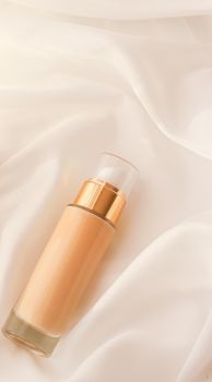 Cosmetic branding, glamour and skincare concept - Tonal bb cream bottle make-up fluid foundation base for nude skin color on silk background, cosmetics product as luxury beauty brand holiday design
