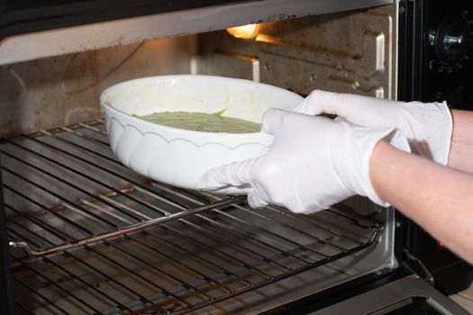 woman baked spinach muffin step by step,puts the form with the dough in the oven, High quality photo