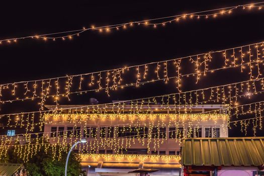 Illuminated swing chain carousel in amusement park at night.