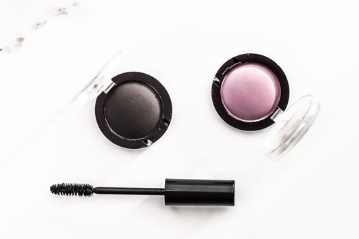 Cosmetic branding, blog and girly concept - Eyeshadows, black liner and mascara on marble background, eye shadows cosmetics as glamour make-up products for luxury beauty brand, holiday flatlay design