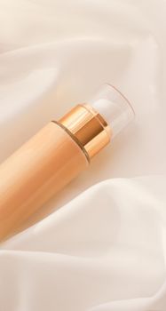 Cosmetic branding, glamour and skincare concept - Tonal bb cream bottle make-up fluid foundation base for nude skin color on silk background, cosmetics product as luxury beauty brand holiday design