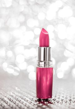 Cosmetic branding, sale and glamour concept - Pink lipstick on silver Christmas, New Years and Valentines Day holiday glitter background, make-up and cosmetics product for luxury beauty brand