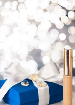 Cosmetic branding, Christmas glitter and girly blog concept - Holiday make-up foundation base, concealer and blue gift box, luxury cosmetics present and blank label products for beauty brand design