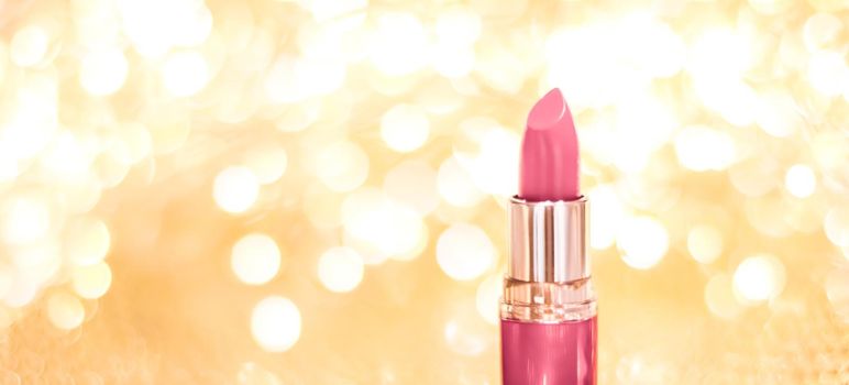 Cosmetic branding, sale and glamour concept - Rose lipstick on golden Christmas, New Years and Valentines Day holiday glitter background, make-up and cosmetics product for luxury beauty brand