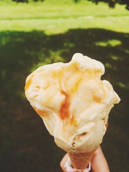 Delicious gelato, organic dairy and homemade recipe concept - Ice cream cone melting outdoors in summer, sweet dessert food on holiday