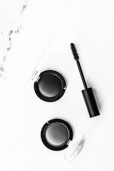 Cosmetic branding, blog and girly concept - Eyeshadows, black liner and mascara on marble background, eye shadows cosmetics as glamour make-up products for luxury beauty brand, holiday flatlay design