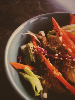 Vegan dieting, eating out and oriental cuisine concept - Vegetarian asian vegetable salad served in a bowl in japanese restaurant, healthy diet food