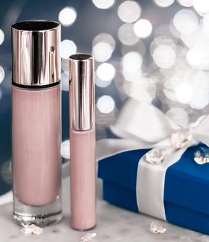 Cosmetic branding, Christmas glitter and girly blog concept - Holiday make-up foundation base, concealer and blue gift box, luxury cosmetics present and blank label products for beauty brand design