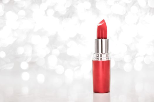 Cosmetic branding, sale and glamour concept - Coral lipstick on silver Christmas, New Years and Valentines Day holiday glitter background, make-up and cosmetics product for luxury beauty brand