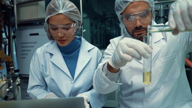 Two scientist in professional uniform working in laboratory for chemical and biomedical experiment