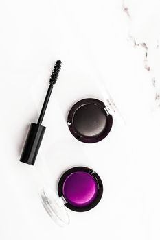 Cosmetic branding, blog and girly concept - Eyeshadows, black liner and mascara on marble background, eye shadows cosmetics as glamour make-up products for luxury beauty brand, holiday flatlay design