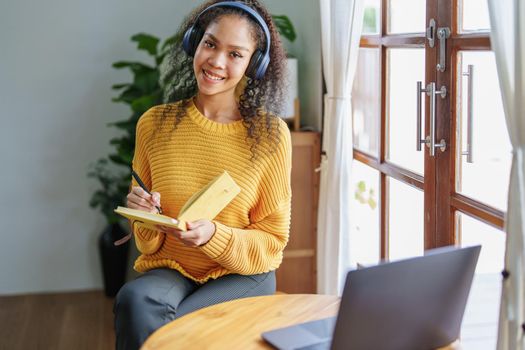 Portrait of African Americans using notebooks, pens to take notes and computers. to study through the Internet, online e learning concept